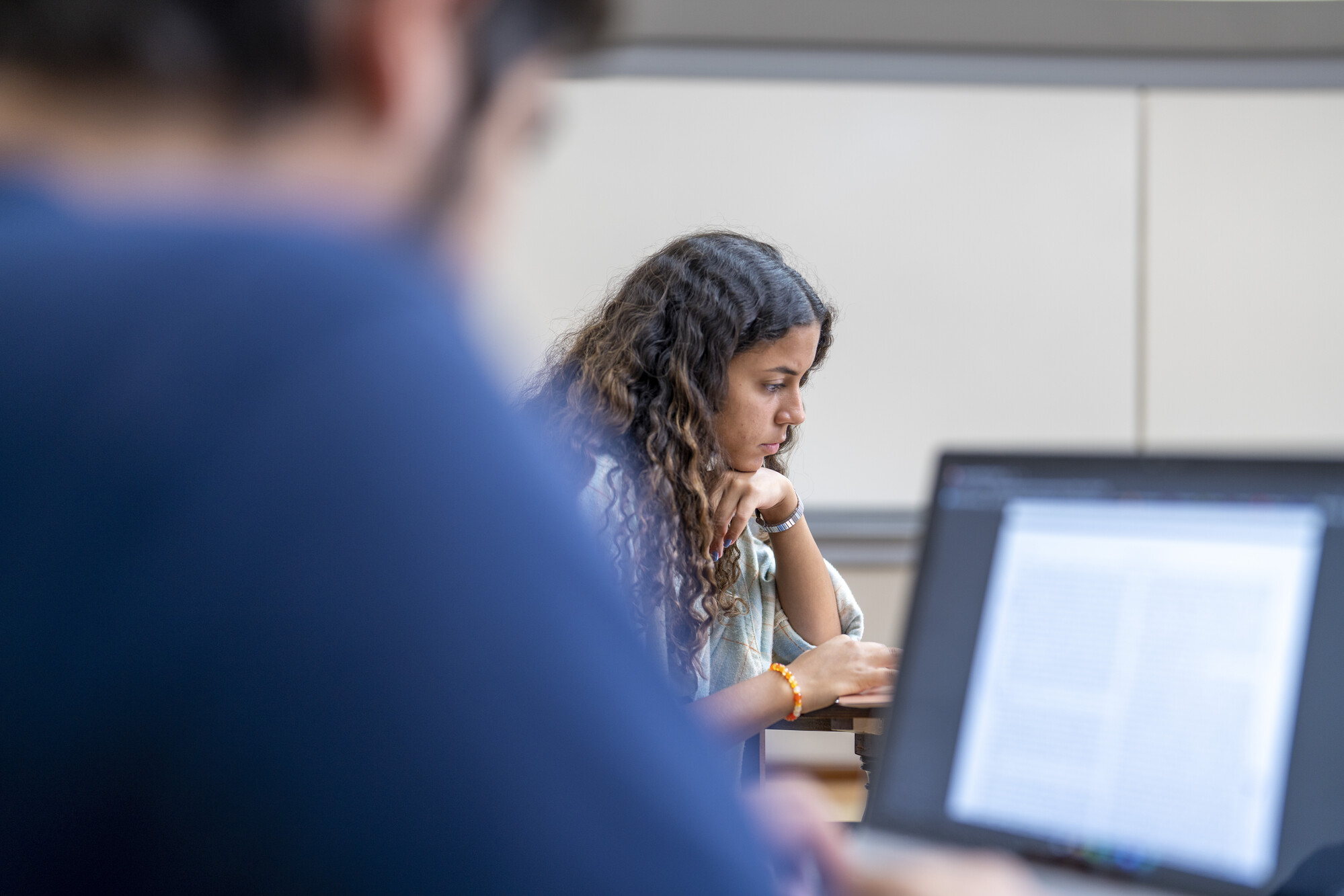 students in class working on a laptop