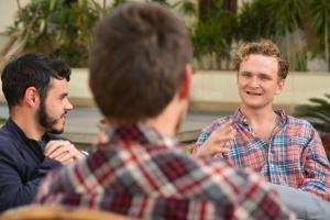 students in group talking outdoors